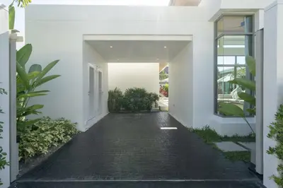 a hallway of a white house with a driveway at SHAMBHALA GRAND Pool Villas x MonthStayZ Thailand in Phuket Town