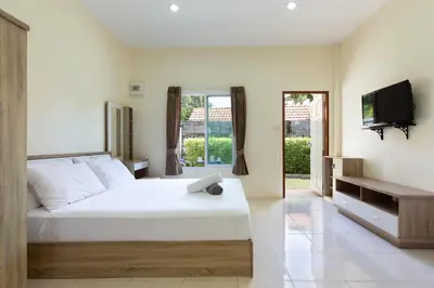 a bedroom with a white bed and a tv at RAWAÏ Bedroom and kitchen in Rawai Beach