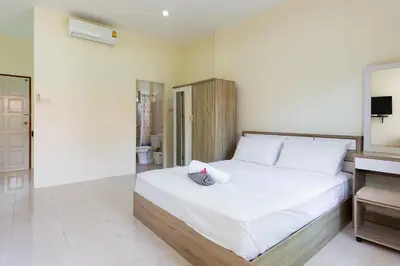 a bedroom with a large bed with white sheets at RAWAÏ Bedroom and kitchen in Rawai Beach