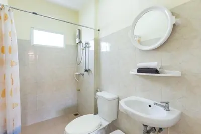 a bathroom with a toilet and a sink and a mirror at RAWAÏ Bedroom and kitchen in Rawai Beach