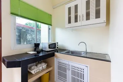 a kitchen with a sink and a counter top at RAWAÏ Bedroom and kitchen in Rawai Beach