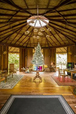 a living room with a christmas tree in the center at AKRA Collection Layan - Hideaway Villas in Layan Beach