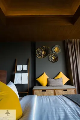 a bedroom with a bed and two plates on the wall at AKRA Collection Layan - Hideaway Villas in Layan Beach