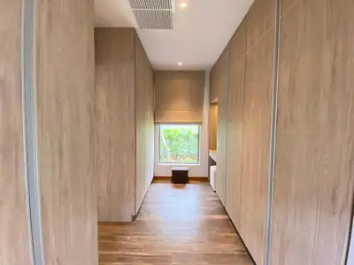 a hallway with wooden walls and a window at Anchan Grand Residence Villa in Phuket Town
