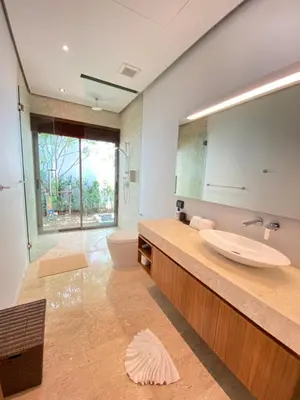 a bathroom with a sink and a mirror at Anchan Grand Residence Villa in Phuket Town