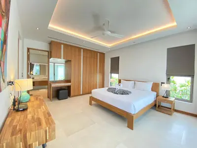 a large bedroom with a bed and a bathroom at Anchan Grand Residence Villa in Phuket Town