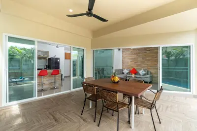 a dining room with a table and chairs at Sabai Villas, 7 min drive from Naiharn & Rawai, Private pool, Four villas available in Rawai Beach