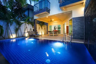 a swimming pool in front of a house at Sabai Villas, 7 min drive from Naiharn & Rawai, Private pool, Four villas available in Rawai Beach