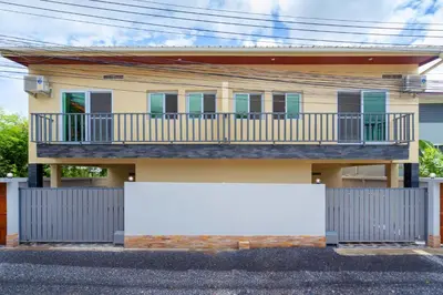 a house with a balcony and a white sign in front at Sabai Villas, 7 min drive from Naiharn & Rawai, Private pool, Four villas available in Rawai Beach