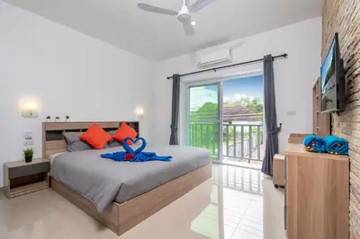 a bedroom with a bed and a balcony at Sabai Villas, 7 min drive from Naiharn & Rawai, Private pool, Four villas available in Rawai Beach