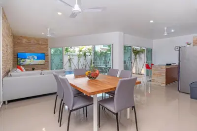 a dining room with a table and chairs and a couch at Sabai Villas, 7 min drive from Naiharn & Rawai, Private pool, Four villas available in Rawai Beach
