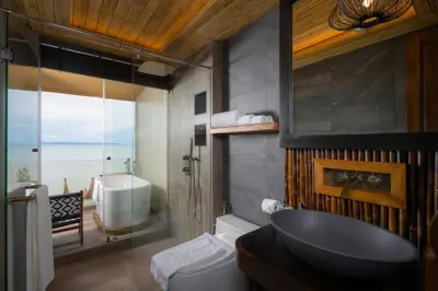 a bathroom with a sink and a toilet and a tub at SINAE Phuket Luxury Hotel in Phuket Town