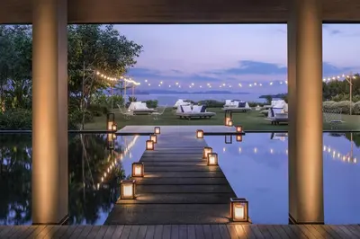 a villa with a swimming pool at night at COMO Point Yamu, Phuket in Ban Pa Khlok
