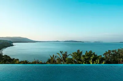 a view of a large body of water with trees at COMO Point Yamu, Phuket in Ban Pa Khlok