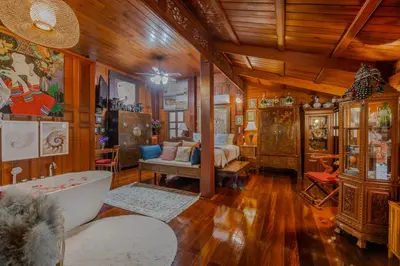 a bathroom with a tub and a bed in a room at Royal Thai Villa Phuket - SHA Extra Plus in Rawai Beach