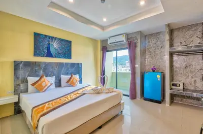 a bedroom with a large bed and a television at TJ Patong Hotel - Otop Shopping Paradise in Patong Beach
