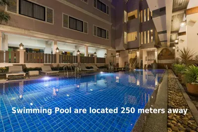 a swimming pool are located in a hotel at TJ Patong Hotel - Otop Shopping Paradise in Patong Beach