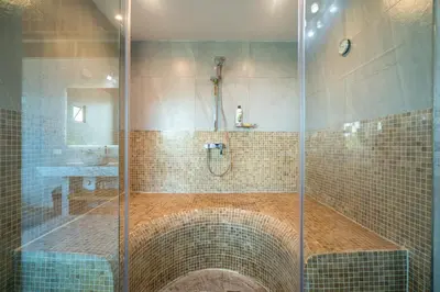a shower with a glass door in a bathroom at Villa Stan in Kamala Beach