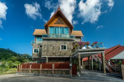 a house with a roof on top of it at Villa Stan in Kamala Beach