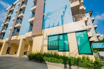 a building with large windows on the side of it at Aim House in Patong Beach