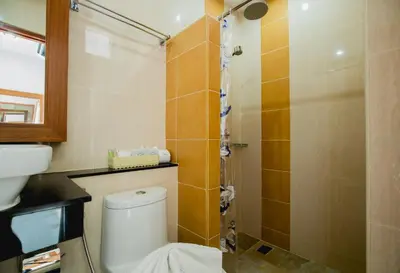 a bathroom with a toilet and a shower at Aim House in Patong Beach