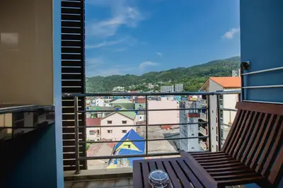 a balcony with a bench and a view of a city at Aim House in Patong Beach