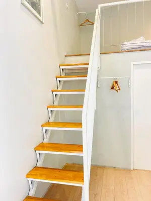a staircase in a tiny home with wooden steps at THE BELONG BOUTIQUE HOTEL in Phuket Town