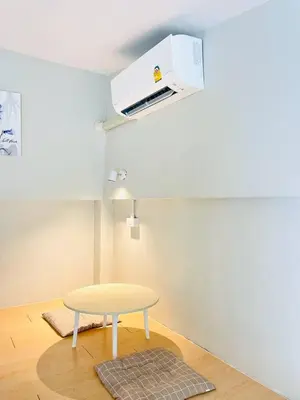 a room with a table and a ceiling fan at THE BELONG BOUTIQUE HOTEL in Phuket Town