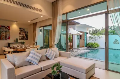a living room with a couch and a pool at Shambhala grand villa by Cozy Lake in Bang Tao Beach
