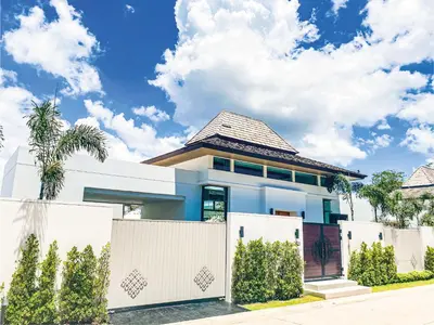 a house with a white fence in front of it at Shambhala grand villa by Cozy Lake in Bang Tao Beach