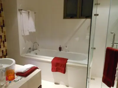 a bathroom with a tub and a red towel at Top Floor, One-Bedroom Apartment in Phuket Town