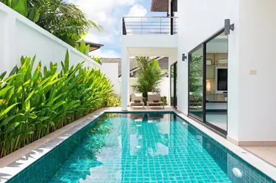 an infinity pool in the backyard of a villa at Villa White Pool in Kamala Beach