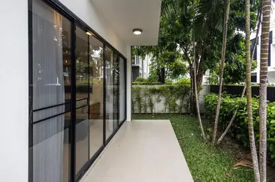 an external view of a house with glass doors at Hot! Laguna Park 5BR Modern Pool Villa - Bangtao Beach in Bang Tao Beach