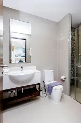 a bathroom with a sink and a toilet and a mirror at Hot! Laguna Park 5BR Modern Pool Villa - Bangtao Beach in Bang Tao Beach