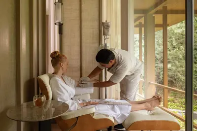 a man giving a woman a massage in a room at Anantara Layan Phuket Resort in Layan Beach