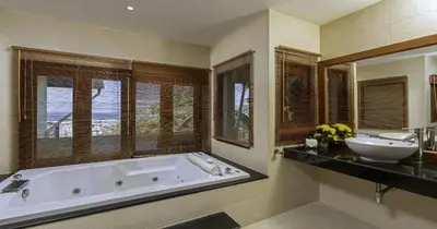 a large bathroom with a tub and a sink at Villa Yoosook in Patong Beach