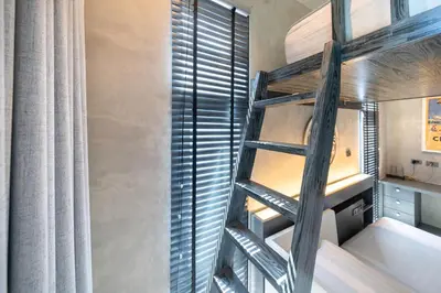 a room with a bunk bed and a ladder at Villa Lami - Luxury 3-Bedroom Modern Villa in Phuket with Private Pool, Gym & Sauna in Phuket Town