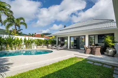 a backyard with a swimming pool and a house at Villa Ayan, Amazing Pool, 2 bedrooms Near Nai harn Beach in Rawai Beach