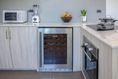 a kitchen with a stainless steel oven in a kitchen at Villa Ayan, Amazing Pool, 2 bedrooms Near Nai harn Beach in Rawai Beach