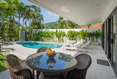 a patio with a table and chairs and a pool at Villa Ayan, Amazing Pool, 2 bedrooms Near Nai harn Beach in Rawai Beach