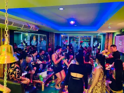 a crowd of people sitting in a room at Popeyes Hostel Patong in Patong Beach
