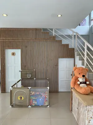 a teddy bear sitting on a table in a room at The CHU cafe / guesthouse in Nai Harn Beach