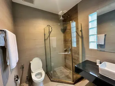 a bathroom with a shower and a toilet and a sink at Villa Tara nr Layan Beach in Bang Tao Beach