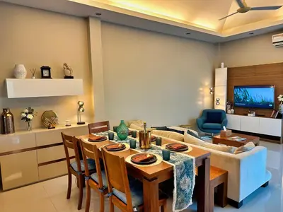 a living room with a table and a couch at Villa Tara nr Layan Beach in Bang Tao Beach