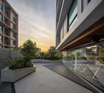 a courtyard of a building with a sunset in the background at Travelodge Phuket Town in Phuket Town