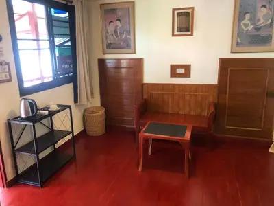 a living room with a bench and a table at Phi Phi Dream Guest House in Phi Phi Don