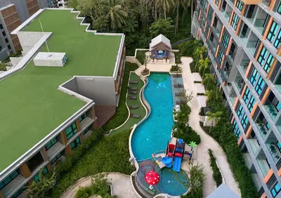 an aerial view of a swimming pool in a resort at Suite Vela 1BR Infinity Pool Mida Grande Surin in Surin Beach