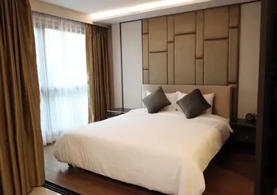 a bedroom with a large white bed with two pillows at Suite Vela 1BR Infinity Pool Mida Grande Surin in Surin Beach