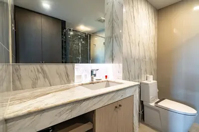 a bathroom with a sink and a toilet at Suite Calista 2BRView JacuzziMida Grande Surin in Surin Beach