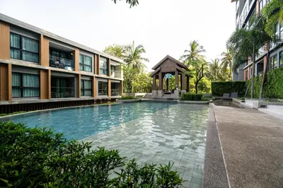 a swimming pool in front of a building with a gazebo at Suite Calista 2BRView JacuzziMida Grande Surin in Surin Beach